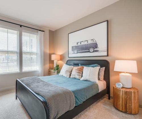a bedroom with a bed and a picture of a car at National At Society in Virginia Beach