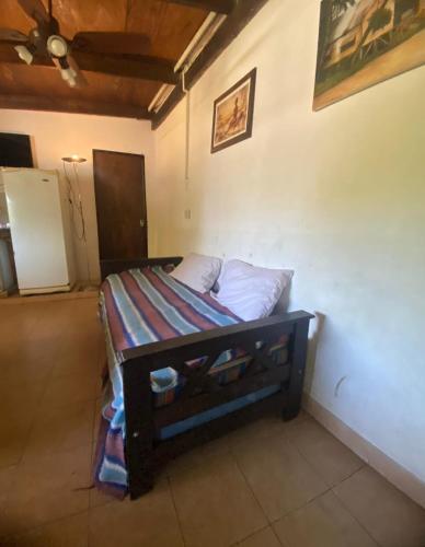 a small bed in a room with a bed frame at Hace tu vida in Tigre
