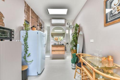 a kitchen with a white refrigerator and a table at Pats garden room with mini cinema, projector in Alkmaar