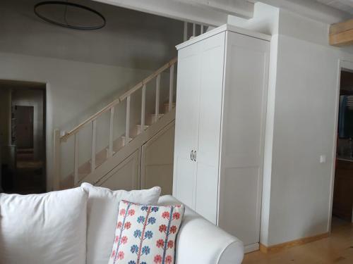 a white cabinet in a living room with a white couch at KATIKIA ZAGORI in Vitsa
