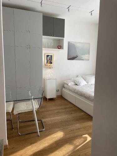 a bedroom with a bed and a glass table at A UN PASSO DALL'OSPEDALE in Padova