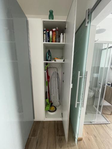 a walk in closet with a glass door at A UN PASSO DALL'OSPEDALE in Padova