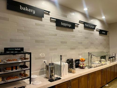 a bakery with a counter with pastries on it at Holiday Inn Orlando International Airport by IHG in Orlando