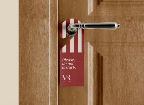 a doorhandle with a sign on a door at Vico Regio Hotel in Casarano