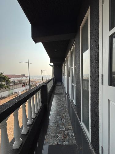 a balcony of a building with a view of the beach at Baga Beach Sea Salacia in Goa