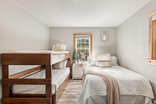 a bedroom with two bunk beds and a window at Belleayre Mountain House in Arkville