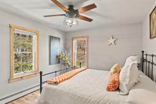 a bedroom with a bed with a ceiling fan at Belleayre Mountain House in Arkville
