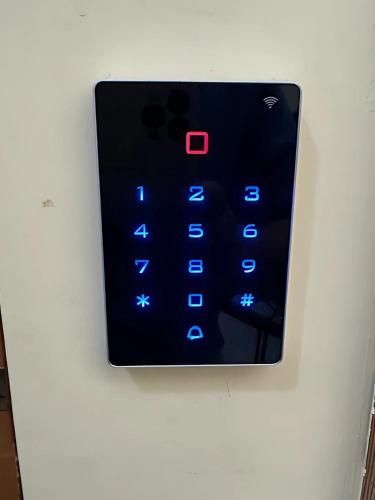 an electronic clock on a wall with blue lights at Rest Guesthouse 2,0 in Melito di Porto Salvo