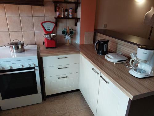 a small kitchen with white cabinets and a counter top at Angelos House in Ýpsos