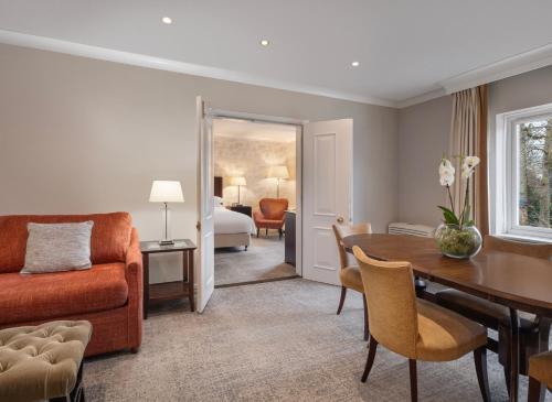 a living room with a couch and a table at Delta Hotels by Marriott Tudor Park Country Club in Maidstone