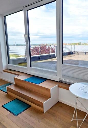 a room with a large window with mats on the floor at Fjordhaus Schleiwind in Fahrdorf