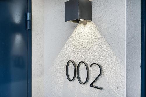 a door with a number on a wall at JIJI Suites in Combs-la-Ville