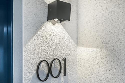 a black light on a wall with a sign on it at JIJI Suites in Combs-la-Ville