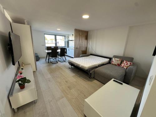a living room with a couch and a table at Moderne FerienWohnung NeuBau Merzig in Merzig