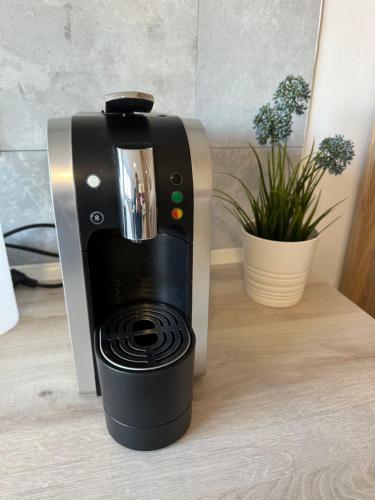 a coffee machine is sitting on a table at Moderne FerienWohnung NeuBau Merzig in Merzig