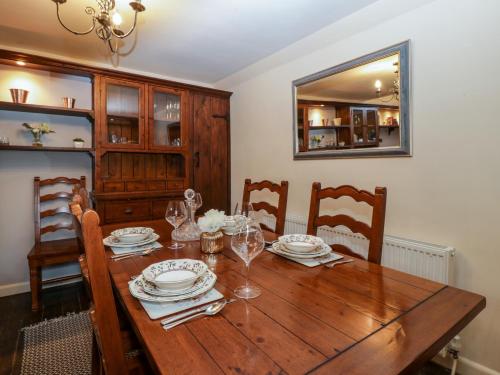 a dining room table with plates and glasses on it at The Old Cider Press in Broadway