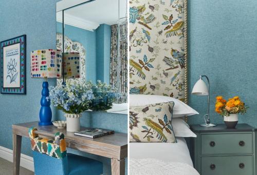 a bedroom with blue walls and a table with a mirror at Warren Street Hotel in New York