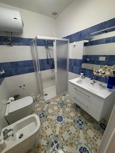 a bathroom with a shower and a toilet and a sink at Vendicari in Pachino