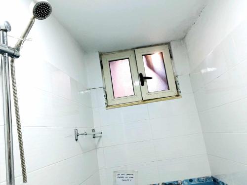 a bathroom with a shower and a window at Stairway to heaven in Shkodër