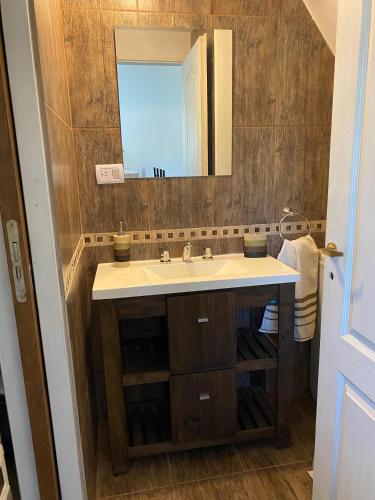 a bathroom with a sink and a mirror at Cabaña Rubí, Complejo El Colibrí in Villa del Dique