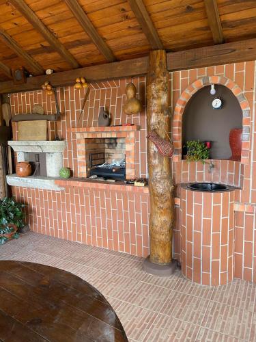 a kitchen with a brick fireplace in a house at casa Pinto Douro country in Ancede