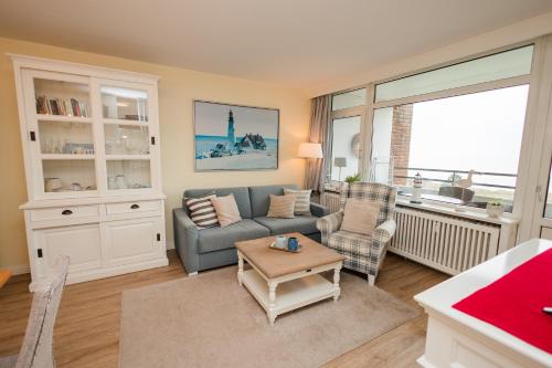 a living room with a couch and a table at Haus Oland Wohnung 21 in Wyk auf Föhr