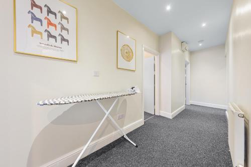 a room with white walls and a walk in closet at Spacious London 2-Bed Flat with a King Bed-Save on Long Stays-5 Separate Beds- Parking Available! in Barnet