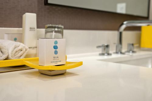 a bottle of soap sitting on a yellow stand in a bathroom at Caesars Palace Hotel & Casino in Las Vegas