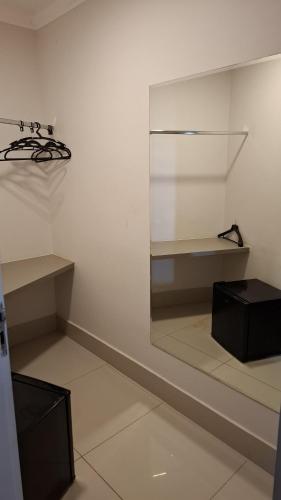 a white room with shelves and a glass wall at Hotel PrimeInn in Campinas