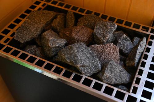 a basket of rocks sitting on a shelf at Green Tiny Village Harz - Sleep Space 32 in Osterode
