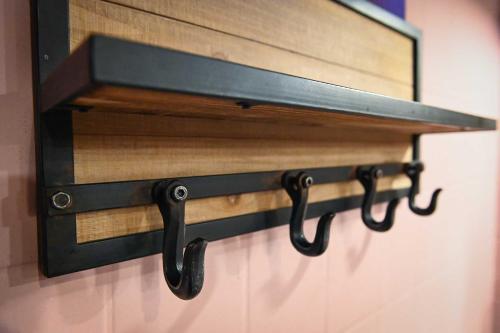 a black towel rack hanging on a wall at Green Tiny Village Harz - Sleep Space 33 in Osterode