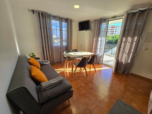 a living room with a couch and a table at Autonomia House I in Câmara de Lobos