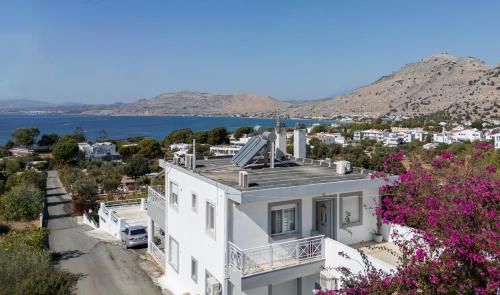 an aerial view of a white house with flowers at POUNEDES LUXURY SUITES in Pefki Rhodes