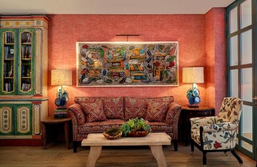 a living room with a couch and a painting on the wall at Warren Street Hotel in New York