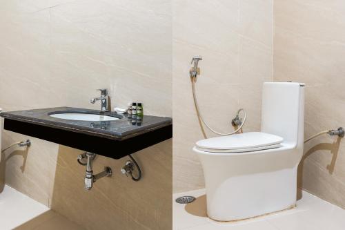 a bathroom with a toilet and a sink at Usha Residency in Varanasi