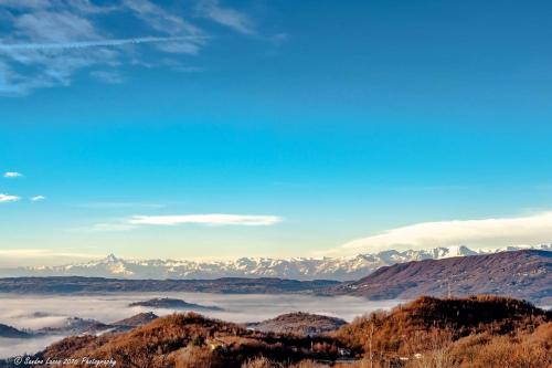 a view of the mountains and clouds in the valley at Cascina Brunod in Chiaverano
