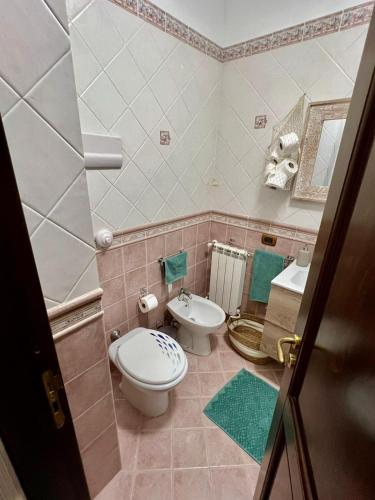 a bathroom with a toilet and a sink at Casa Yasmine in Santa Flavia