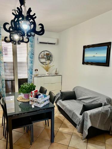 a living room with a table and a couch at Casa Yasmine in Santa Flavia