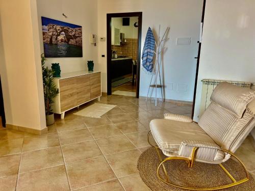 a living room with a chair and a couch at Casa Yasmine in Santa Flavia