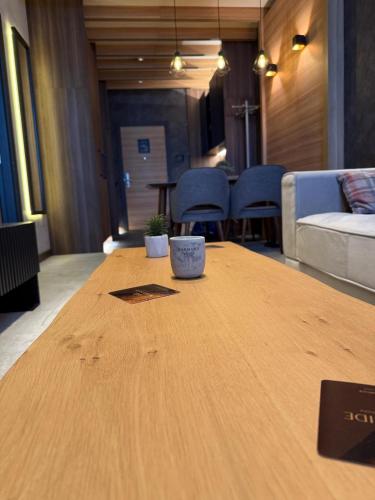 a wooden table in a living room with a couch at Woodside AS family apartment in Raška