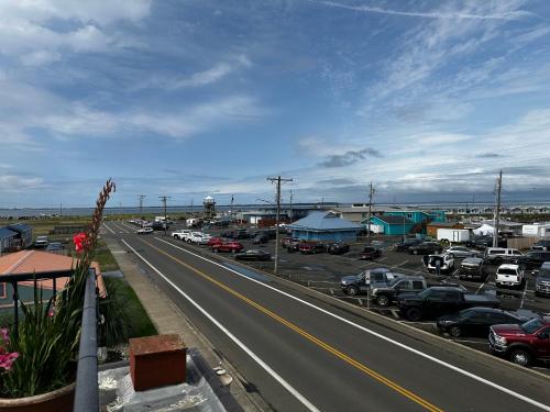 a highway with cars parked in a parking lot at Westport Inn in Westport