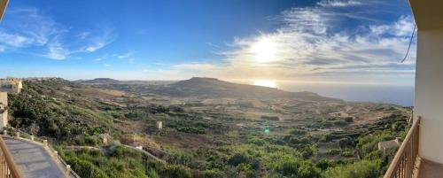 a view of the ocean from a balcony of a house at The Heights 2 Bedroom Apartment in Għasri