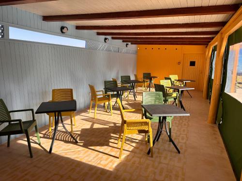 a group of tables and chairs in a room at The Mogador's Oasis in Akermoud