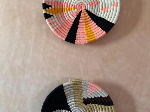 two pieces of art hanging on a wall at The Mogador's Oasis in Akermoud