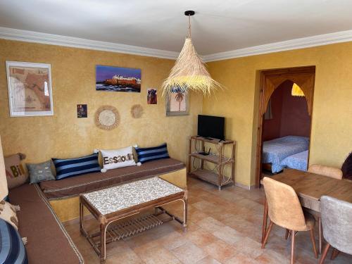 a living room with a couch and a table at The Mogador's Oasis in Akermoud