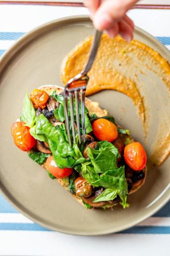 a plate of food with a salad and a fork at Papagayo Golden Palms Beachfront Hotel in Papagayo, Guanacaste
