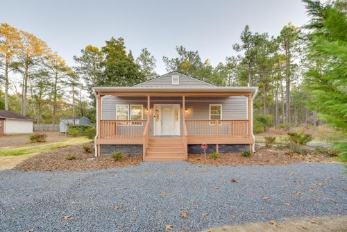 a tiny house with a front porch and a driveway at Sandhills Sanctuary Home Near Golfing! in Southern Pines
