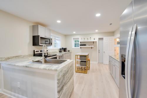 a white kitchen with a sink and a refrigerator at Sandhills Sanctuary Home Near Golfing! in Southern Pines