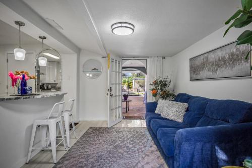 a living room with a blue couch and a kitchen at Heated pool just 1.7 mi to beach The Ocean Pearl in Sarasota