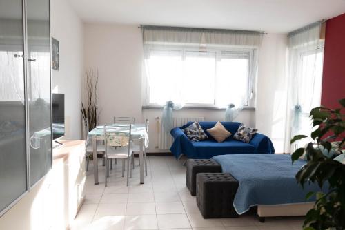 Un dormitorio con una cama azul y una mesa. en Rebby'S Home, en Milán
